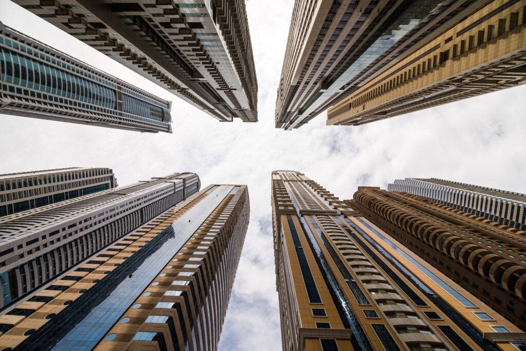 dramatic perspective with low angle view of skyscrapers looking up to the sky, dubai.