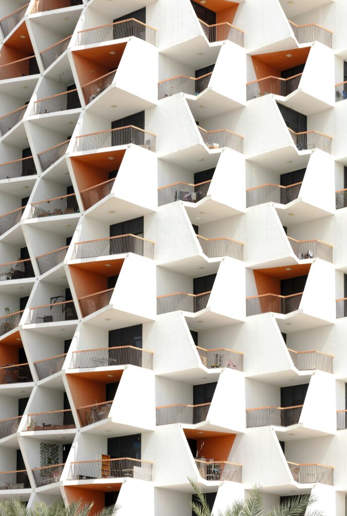 A striking geometric apartment facade with orange accents in Dubai, UAE.